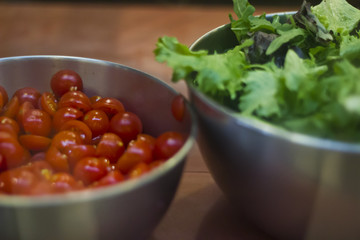 Lettuce and tomatos in metal bowls