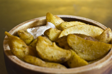 French fries with sauce in a wooden bowl 