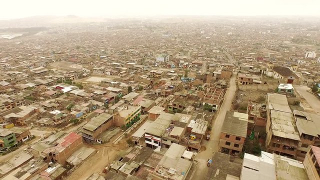 Aerial of Slums in Lima, Peru. Flying over houses.