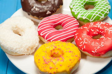Doughnuts on blue wooden table