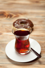 Cup of tea and donuts on a wooden background