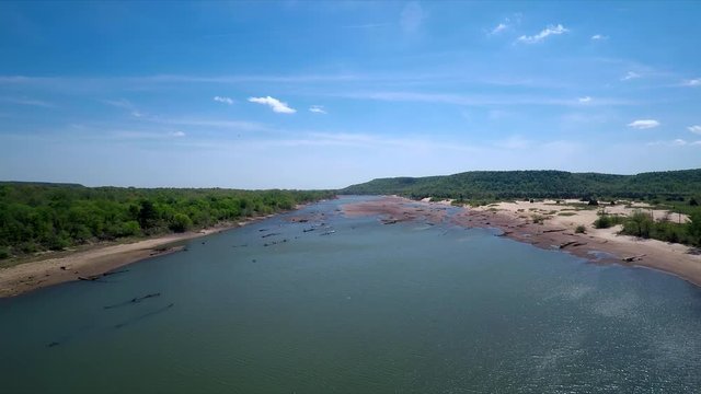 Landscape Aerial Drone down River clear blue water high angle low angle with flying birds Pelicans