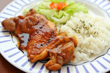 Platter of rice with grilled pork ribs  and lettuce