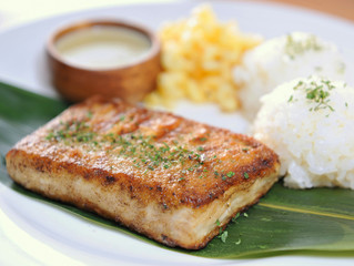Platter of rice with fried fish fillet