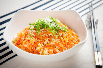 Special carrot salad with egg in white bowl
