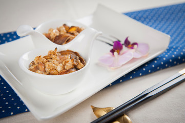 Spoon of shrimp sauteed on white