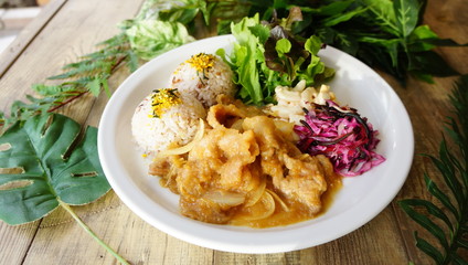 Iron plate napolitan rice with lettuce and salad on wooden table