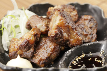 Fried pork ribs in asia on black disk