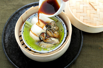 Oyster soup with produce and radish in bamboo tray