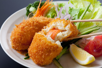 Fried breaded crab meat with cheese on dish