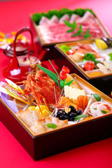 Bento of fresh seafood with lobster, tuna, shrimp and clams on red background