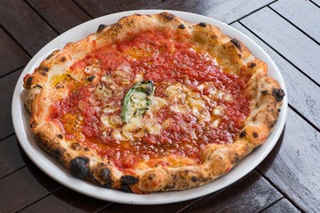 Hot delicious pizza with mushroom and tomatoes on white platter
