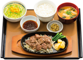 Bento of beafsteak with rice and seaweed soup on table