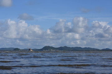 Naklejka na ściany i meble A man is fishing in the Gulf of Thailand