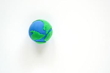 Globe ,earth made from clay on white background. Concept Save green planet. Earth day holiday concept