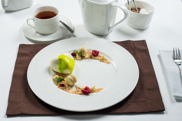 cake of ice cream on a white round plate decorated