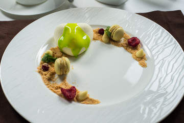 cake of ice cream on a white round plate decorated