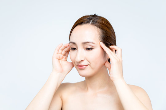 young beauty woman massaging her face. facial massage concept.