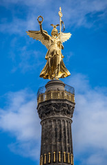 Fototapeta na wymiar Detail of the golden angel of the Siegessaeule (Victory Column) in Berlin, Germany 