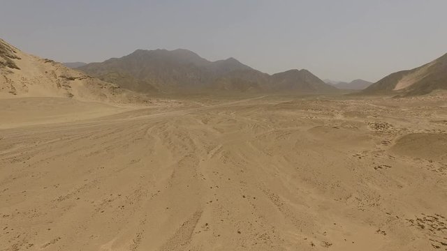 Aerial of sand dunes in a desert in Peru, South America.  Aerial near the city of Caral