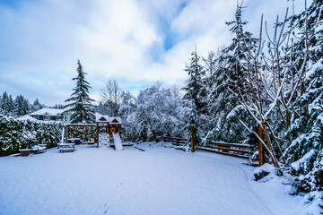Snow covered Play Ground in the Fraser Valley of British Columbia, Canada on a cold winter day and...