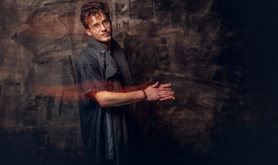 A man with curly hair dressed in a jacket and eyeglasses.