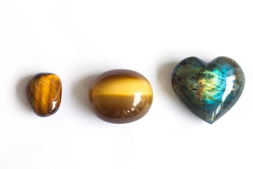 Tiger's eye and heart shape labradorite on white background
