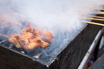 Grilled chicken skewer on charcoal stove , thai street food