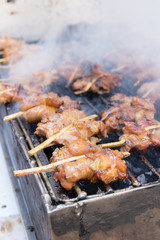 Grilled chicken skewer on charcoal stove , thai street food