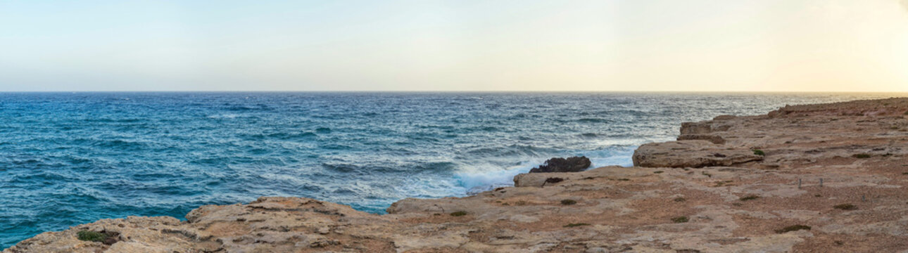 View on Mediterranean Sea from high rock bank at sunset. Cape Greko, Cyprus. 

