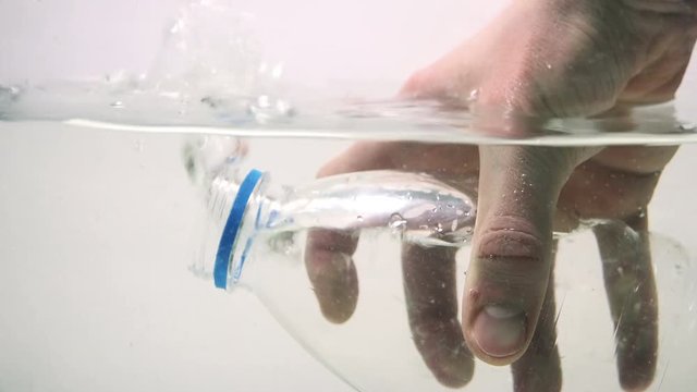 Man Pouring Water in Plastic Bottle. 4K