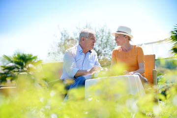 Senior couple enjoying coffee at restaurant outdoor table