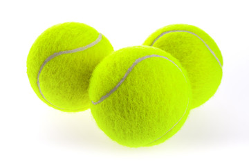 Three isolated yellow tennis balls