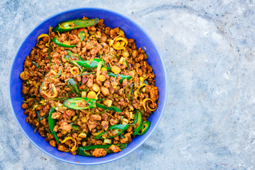 Stir fried pork with yellow curry paste, Thai food.