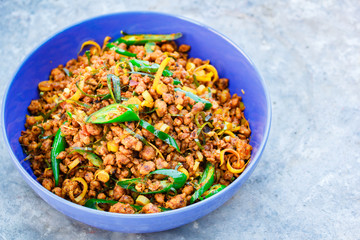 Stir fried pork with yellow curry paste, Thai food.