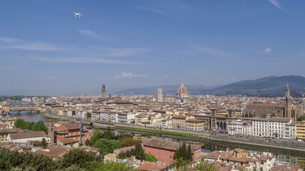 Magnificent panoramic aerial view of the historic center of Florence, Tuscany, Italy, from Piazzale Michelangelo, on a sunny day and a drone flying in the blue sky