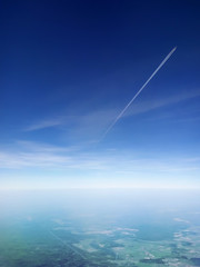 A passenger plane flying in the blue sky, view from another plane flying