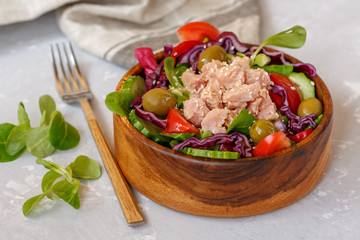 Tuna salad with vegetables and olives. Healthy raw nutrition concept.