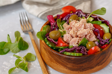 Tuna salad with vegetables and olives. Healthy raw nutrition concept.