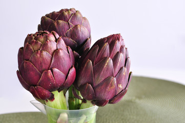 Purple artichokes on a table