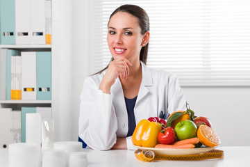 Female dietician showing vegetables and fruit