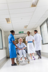 Senior Female Woman Patient in Wheelchair & Nurse in Hospital