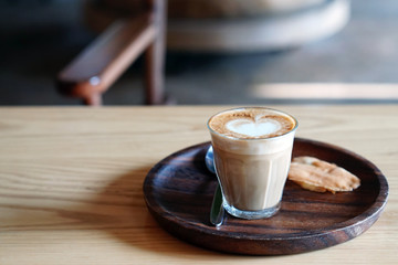 Good morning coffee cup - a cup of hot piccolo with latte art on wooden table and copy space.