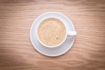 isolated cup of milk coffee on wooden table