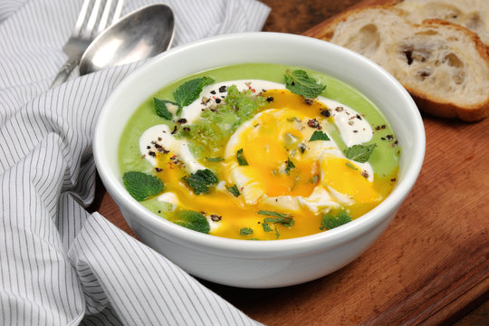 Pea puree soup with poached egg  and peppermint