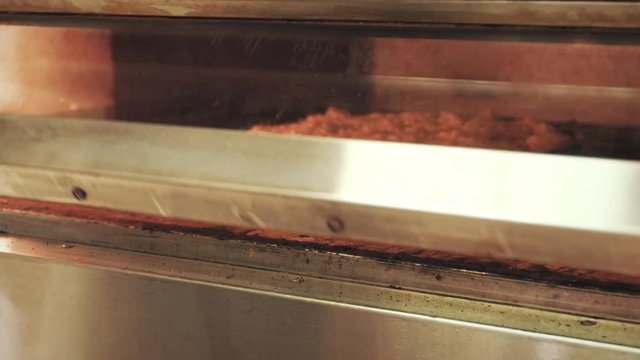 chef sliding American style pan pizzas into the oven