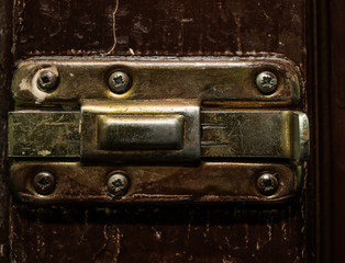 Old vintage bolt on a wooden door