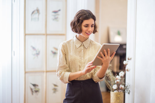 Young smiling female using tablet
