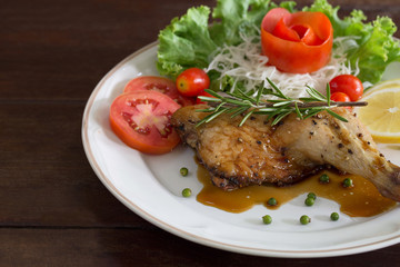 Grilled Chicken steak with black pepper and teriyaki sauce In white dish and vegetables in the basket on the wooden table