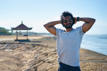 Handsome and confident. Outdoor portrait of happy young african man on the beach.